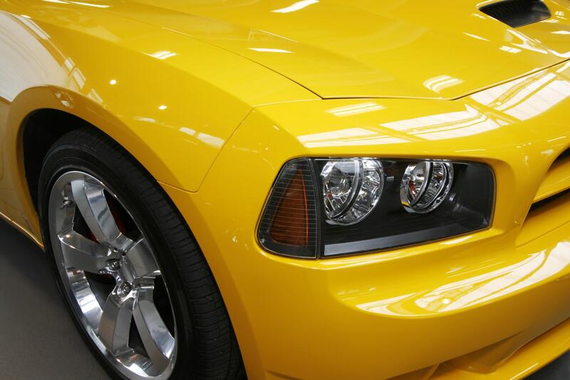 Picture of front of yellow sorts car with paint protection clear bra